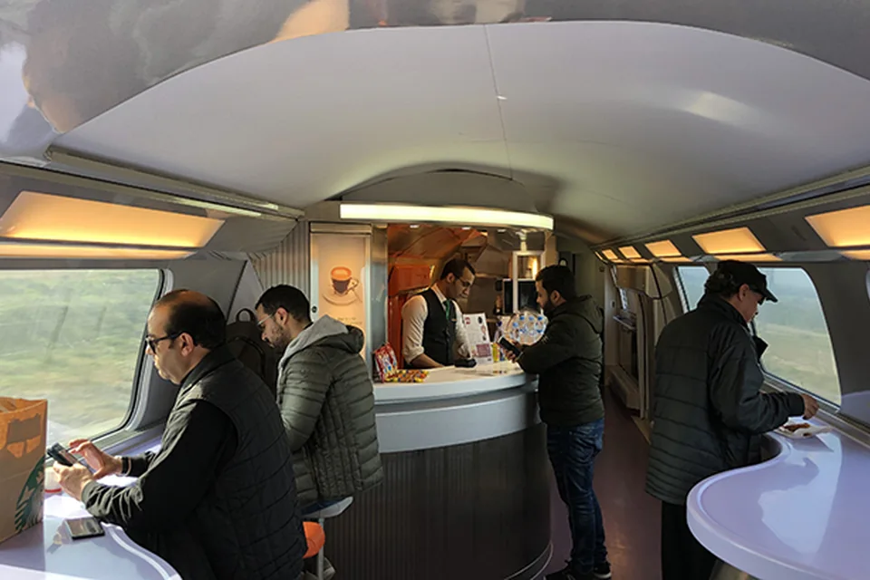 Passengers enjoying the onboard cafe area of a Moroccan train.